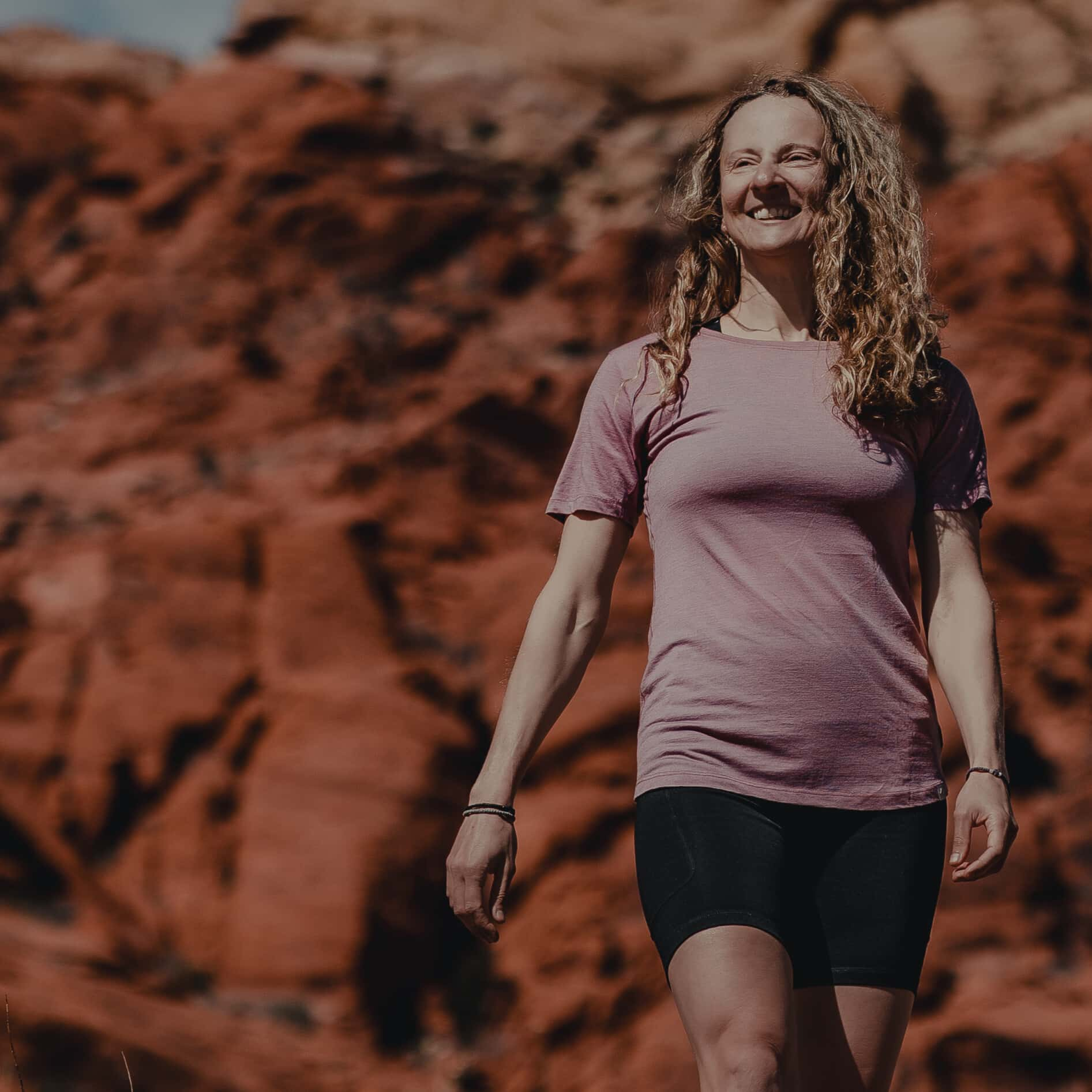 a woman wearing a Wild Rose Pursuit ultralight Merino tee