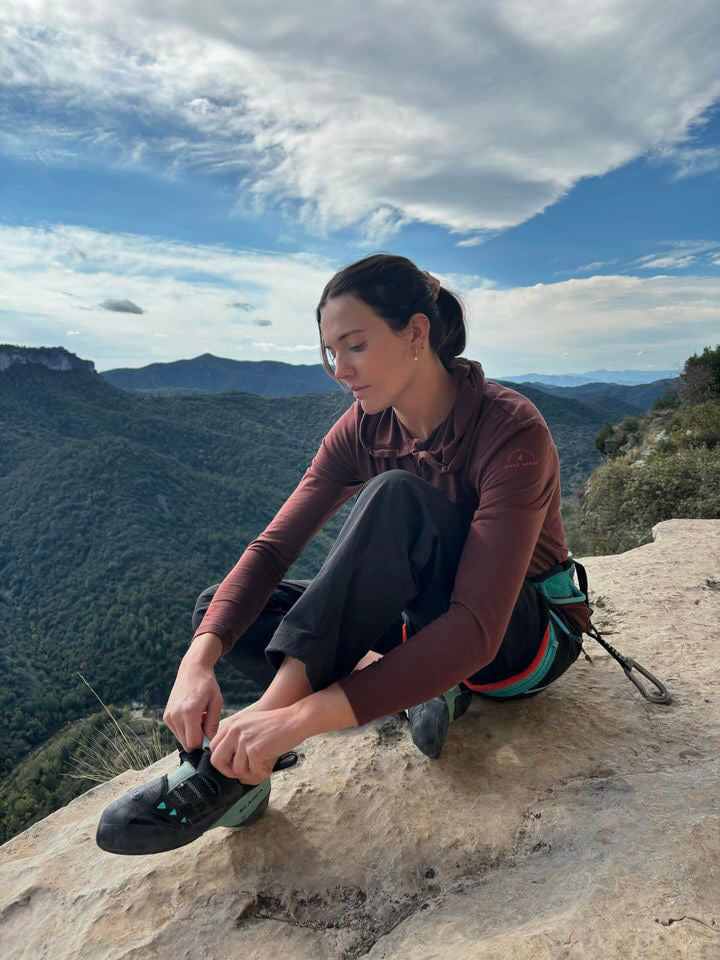 A climber wearing a Solstice Sun Hoodie on a fall climbing trip