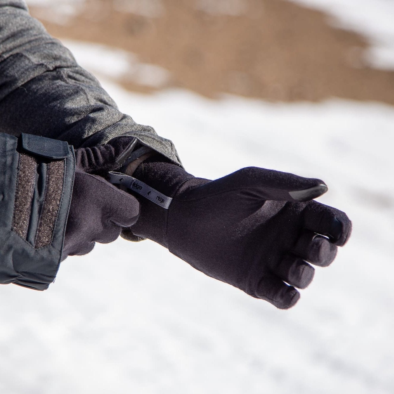 a skier pulls on glove liners