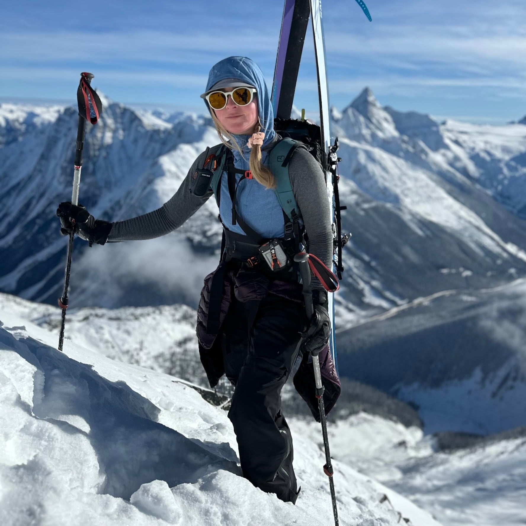 a skier wearing a Convict Canyon Hoodie in Winter Blue