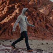 a man wearing a Ridge Solstice Pro Sun Hoodie in the desert