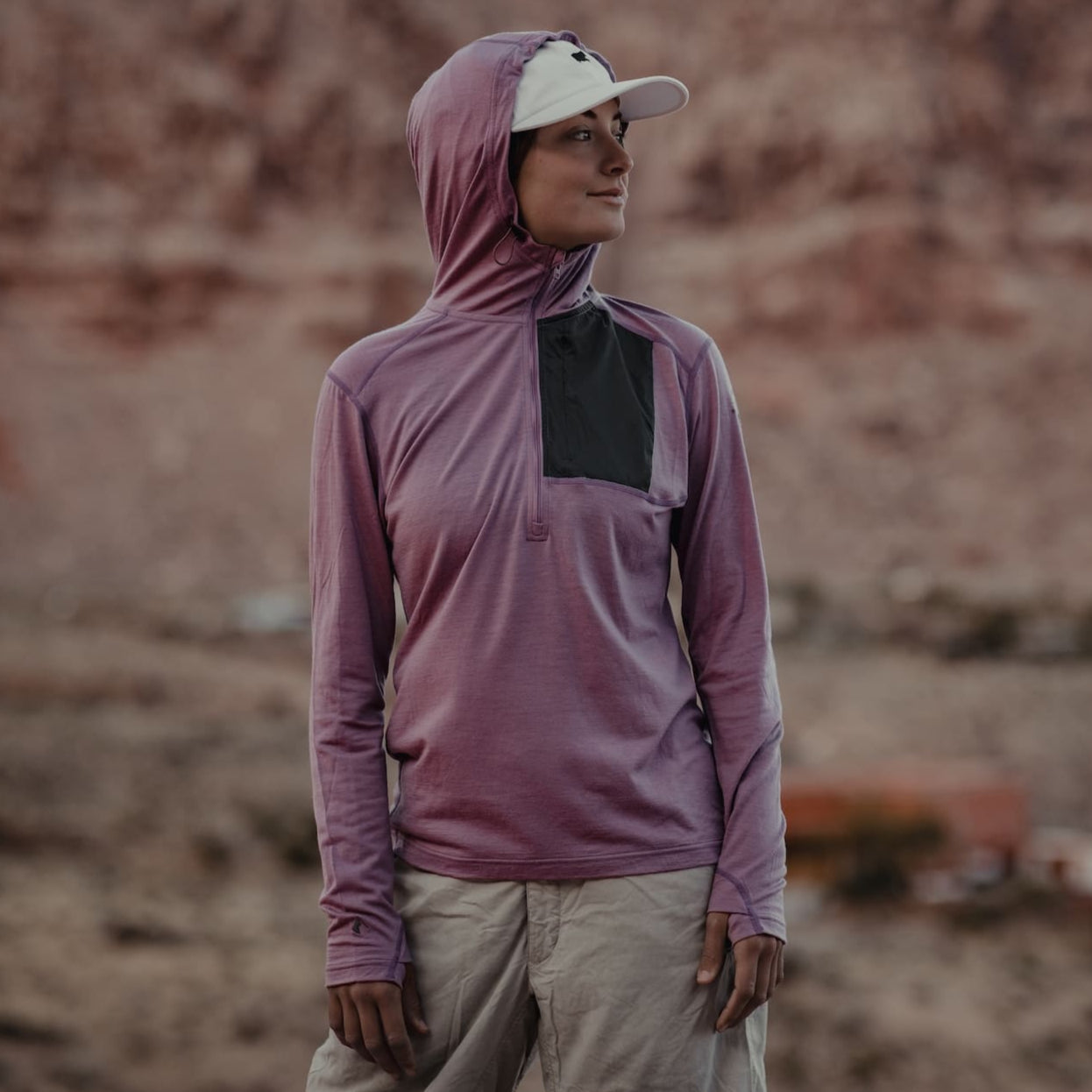 a woman wearing a Ridge Solstice Pro Sun Hoodie and a baseball cap