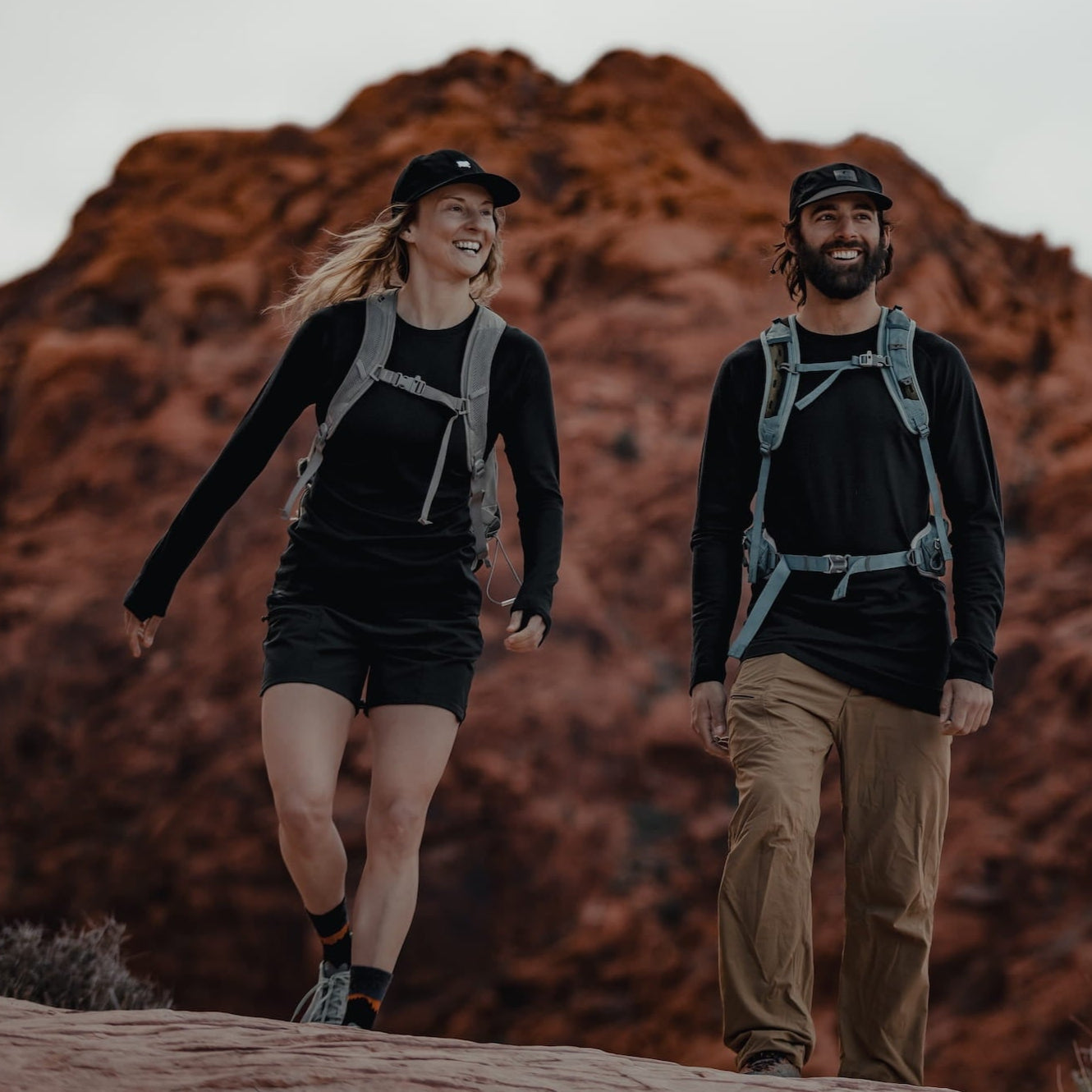 a woman and a man hiking together wearing Ridge Aspect Base Layer Tops