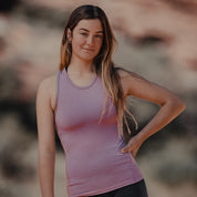 a woman wearing a pink Ridge Racerback Tank