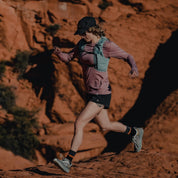 a woman running in Red Rocks in a Pursuit long sleeve ultralight shirt