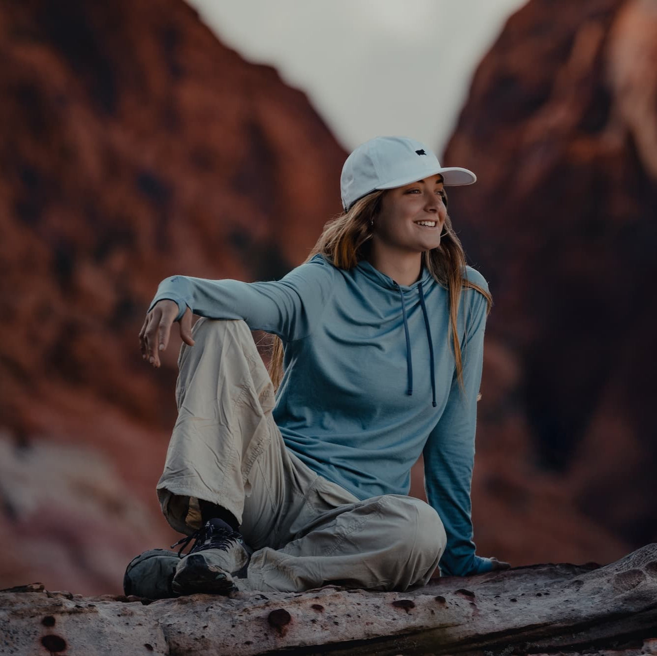 a woman wearing a blue Solstice Sun Hoodie